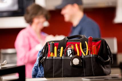 Service Industry: Repairman works at customer's home. Toolbox, tools.